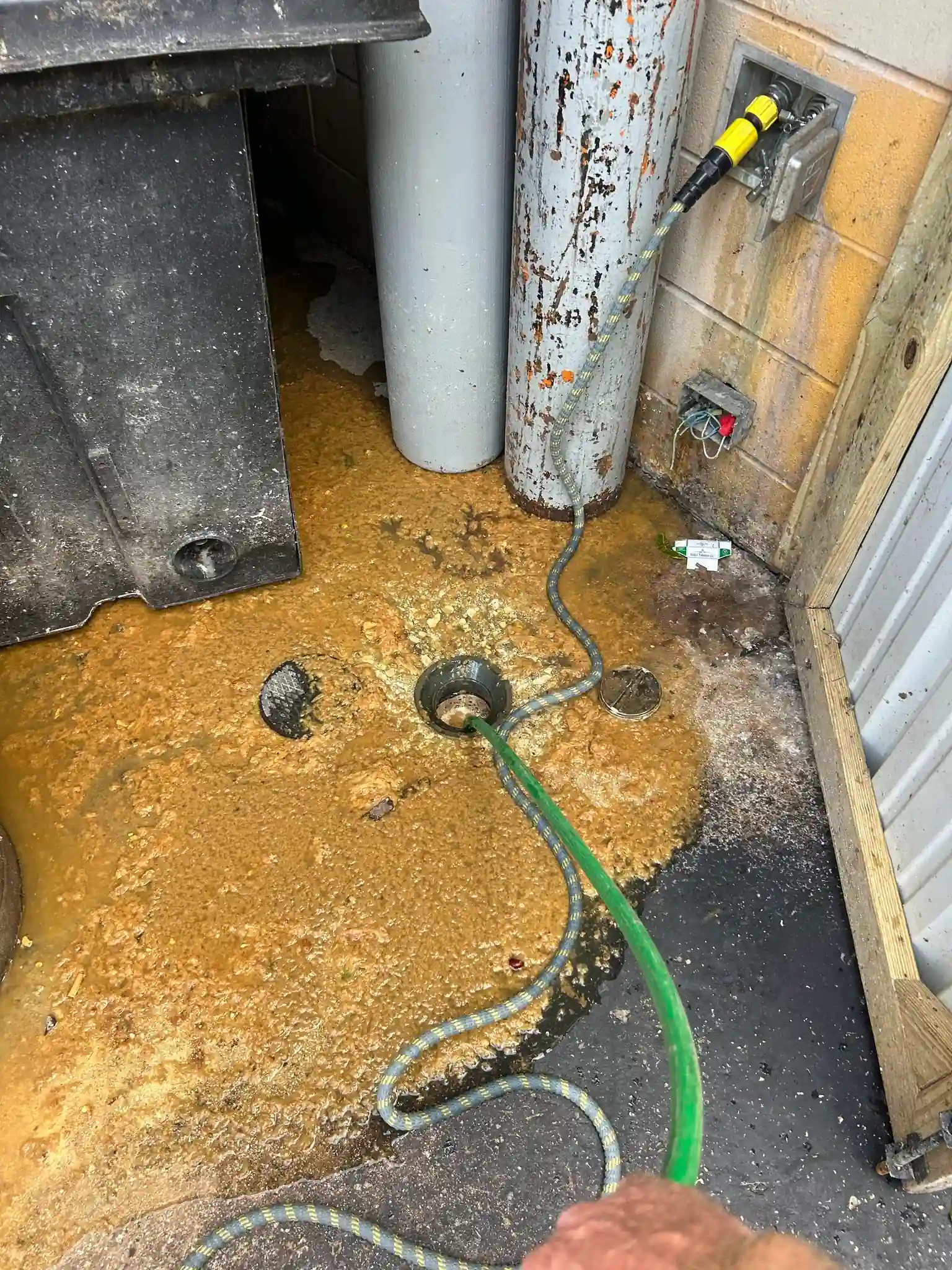 Grease-covered floor drain being hydro jetted at a commercial property in San Antonio, TX